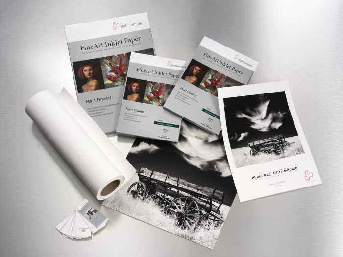 a group of paper rolls and a few inkjet papers